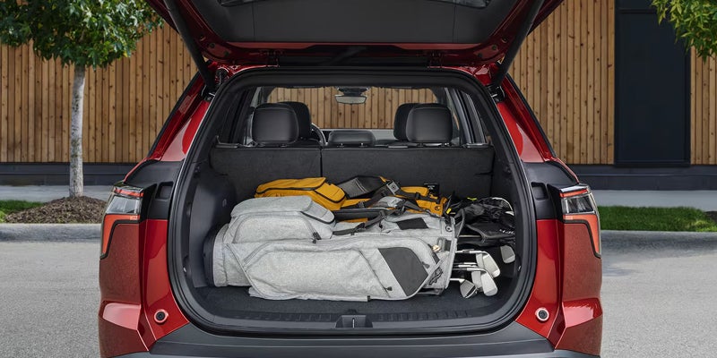 2027 Chevrolet Equinox open rear cargo area with luggage and golf bags