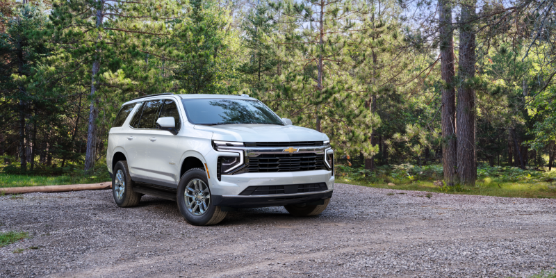 2027 Chevrolet Tahoe LT in Polar White Tricoat parked on a gravel forest road