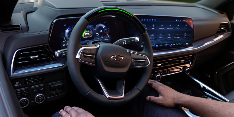 2027 Chevrolet Tahoe cockpit showing available Super Cruise steering wheel light bar and 17.7-inch Google Built-In touchscreen